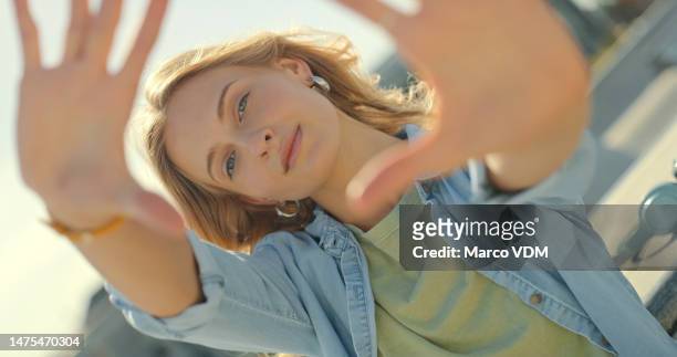 hands frame, fashion and portrait of woman in city for freedom, wellness and confidence in urban town. beauty, creative face and happy girl model in street with makeup, trendy clothes and cosmetics - happy face close up stockfoto's en -beelden