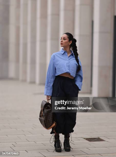 Tara Tut seen wearing Louis Vuitton black logo high boots, Louis Vuitton vintage logo backpack, Zara cropped pinstripes blue blouse and Zara...