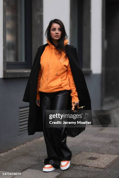 Tara Tut seen wearing an orange Christian Dior hoodie, Copenhagen Studios x The Wants orange and white sneaker, Hermes black bag and Hermes orange...