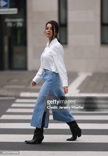 Tara Tut seen wearing Trendyol blue denim long skirt, Zara cropped silk white blouse and Zara brown and black Cowboy boots and golden earrings on...