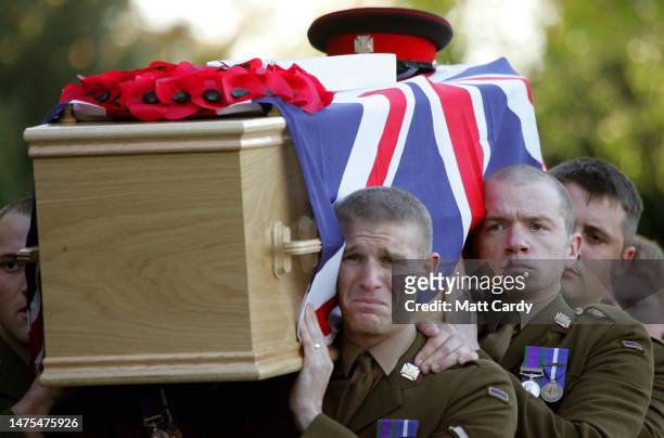 Grief is etched on the face of a pallbearer carrying the Union Jack draped coffin of Lance Corporal Steven Gregory Sherwood being carried into St...