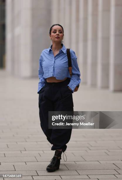 Tara Tut seen wearing Louis Vuitton black logo high boots, Louis Vuitton vintage logo backpack, Zara cropped pinstripes blue blouse and Zara...