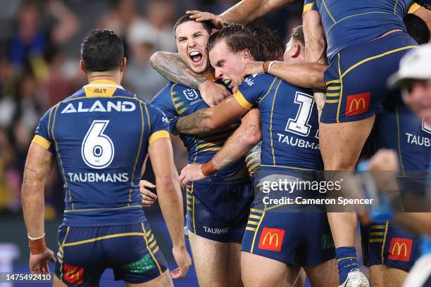 Mitchell Moses of the Eels celebrates with team mates after kicking a field-goal in extra time to win the round four NRL match between the Parramatta...