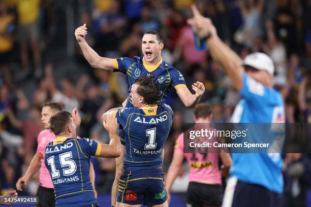 Mitchell Moses of the Eels celebrates with team mates after kicking a field-goal in extra time to win the round four NRL match between the Parramatta...