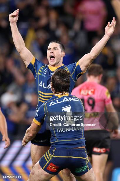 Mitchell Moses of the Eels celebrates with team mates after kicking a field-goal in extra time to win the round four NRL match between the Parramatta...