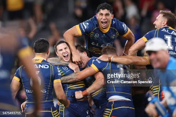 Mitchell Moses of the Eels celebrates with team mates after kicking a field-goal in extra time to win the round four NRL match between the Parramatta...