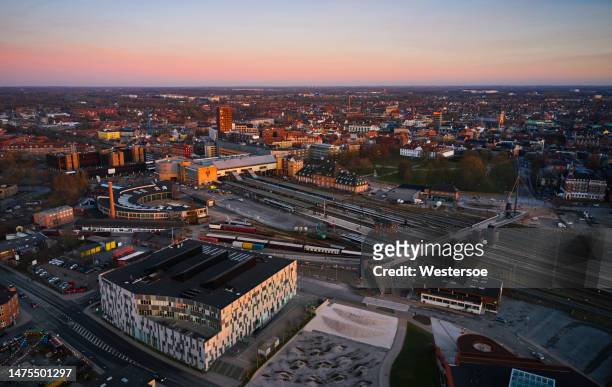 sunset over odense railway station - odense denmark stock pictures, royalty-free photos & images
