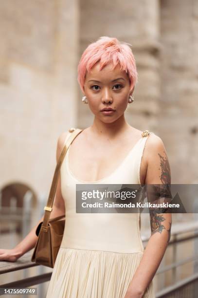 Mia Kong with pink hair is seen wearing long beige maxi dress and brown bag outside Lanvin Paris Fashion Week - Womenswear Fall Winter 2023 2024 :...