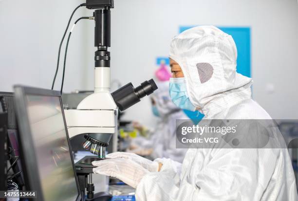 An employee checks semiconductor chips at a microelectronics enterprise on March 23, 2023 in Hai'an, Jiangsu Province of China.