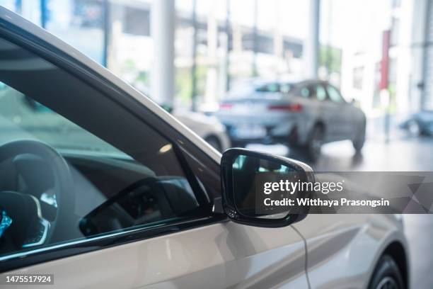 new cars at dealer showroom - car sedan stock pictures, royalty-free photos & images