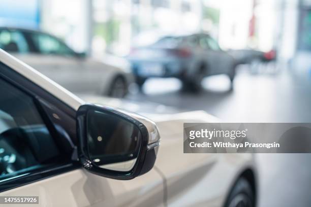 new cars at dealer showroom. blurred background - car display background stock pictures, royalty-free photos & images