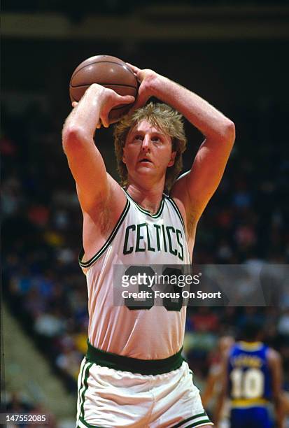 Larry Bird of the Boston Celtics shoots a free-throw against the Indiana Pacers during an NBA basketball game circa 1984 at The Boston Garden in...