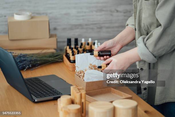 female entrepreneur is packing a box with cosmetics at home. - beauty salon ukraine - fotografias e filmes do acervo