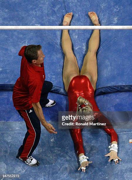 Nastia Liukin falls off the uneven bars in front of coach, Valeri Liukin during day 4 of the 2012 U.S. Olympic Gymnastics Team Trials at HP Pavilion...