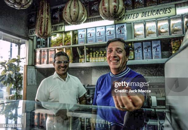 The proprietors of Fiore Italian delicatessen offering imported delicacies in Hoboken, New Jersey, September 1977.