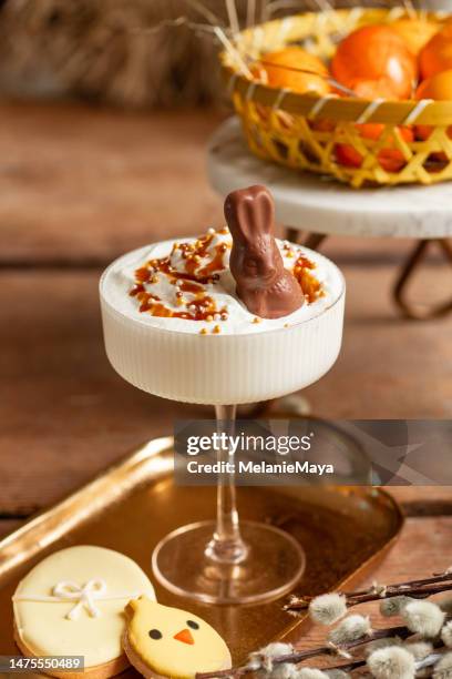 easter themed cocktail aperitif drink with chocolate bunny and easter cookies - creme eggs stock pictures, royalty-free photos & images