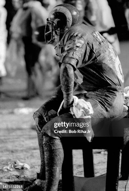 Muddy Rams Jack Youngblood takes a break during rainstorm at NFC Playoff Game between Los Angeles Rams and Minnesota Vikings, December 26, 1977 in...