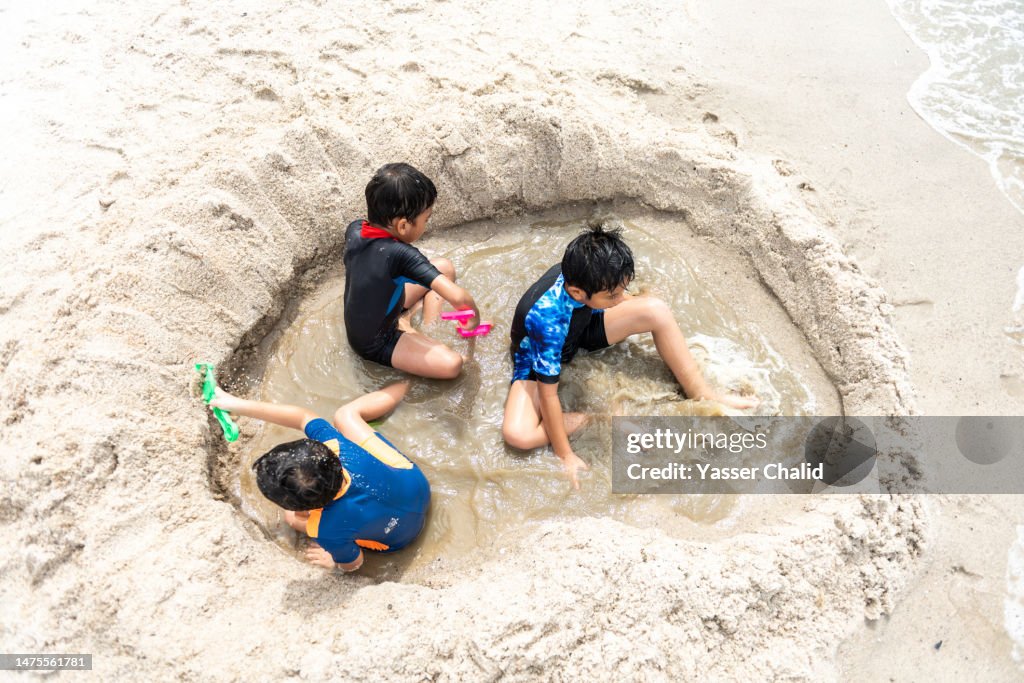 Children Build Fort on a Beach