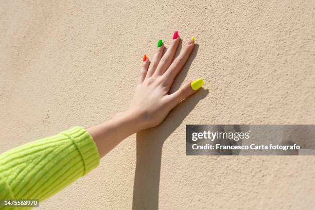 woman fingers with multicolor nail art manicure - manicure foto e immagini stock