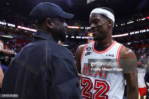 Former Miami Heat player Dwyane Wade and Jimmy Butler of the Miami Heat meet on the court after a game against the New York Knicks at Miami-Dade...