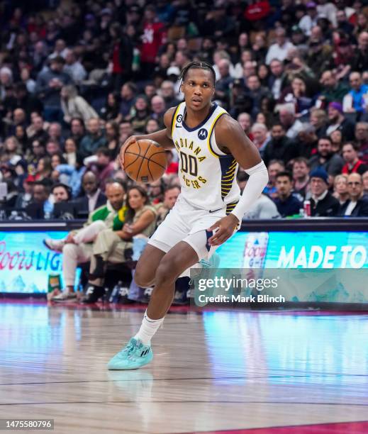Bennedict Mathurin of the Indiana Pacers dribbles against the Toronto Raptors during the first half of their basketball game at the Scotiabank Arena...