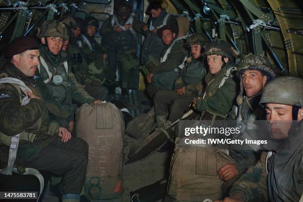 British paratroopers sitting in the fuselage of an aircraft during training for D-Day, wait for their order to jump, Britain, 1944.