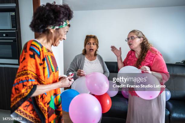 senior friends preparing the birthday party at home - neighbours arguing stock pictures, royalty-free photos & images