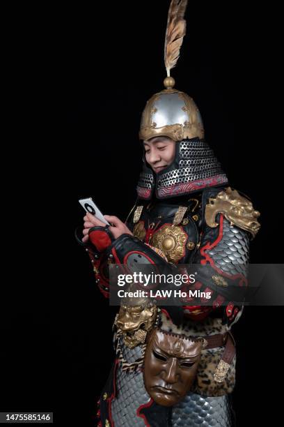 a man in armor using a cell phone - military body armor stock pictures, royalty-free photos & images