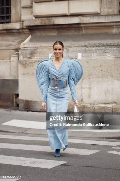 Nina Sandbech is seen wearing denim long maxi skirt, denim top in a shape of a heart, wide denim belt, denim long boots and silver bag during Paris...