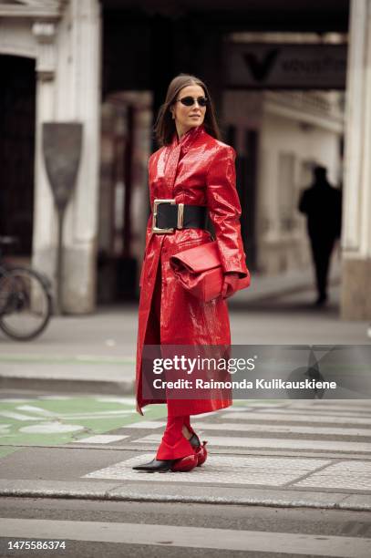 Nina Sandbech is seen wearing full red outfit, red pants, red long leather coat, red bag, red leather gloves, black wide belt, Loewe shoes with...