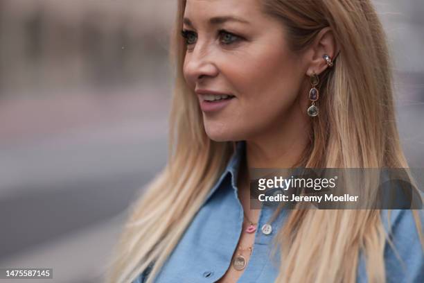 Tanja Comba seen wearing SoSue blue denim button blouse, Friday Atelier necklaces and earrings, on March 20, 2023 in Cologne, Germany.
