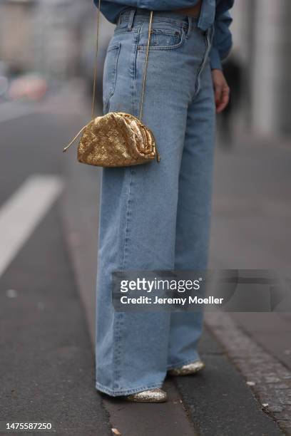 Tanja Comba seen wearing SoSue blue denim button blouse, Agolde blue wide leg denim pants via Aest Store, Bottega Veneta gold metallic leather mini...