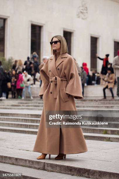 Helena Bordon is seen wearing oversized brown belted wool coat, brown shoes and black sunglasses outside the Elie Saab show during Paris Fashion Week...