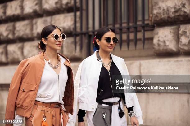 Twins Snehal and Jyoti Babani is seen wearing an orange leather Hermes jacket and matching leather pants, with a white blouse, gold chain, sunglasses...