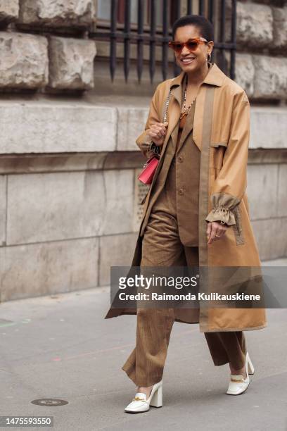 Tamu McPherson is seen wearing orange frame sunglasses, a camel brown colour braided wool shoulder-off t-shirt, a brown ribbed velvet blazer jacket,...