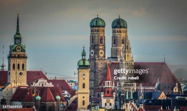church steeples and clock towers in munich altstadt - munich germany - catedral de múnich fotografías e imágenes de stock