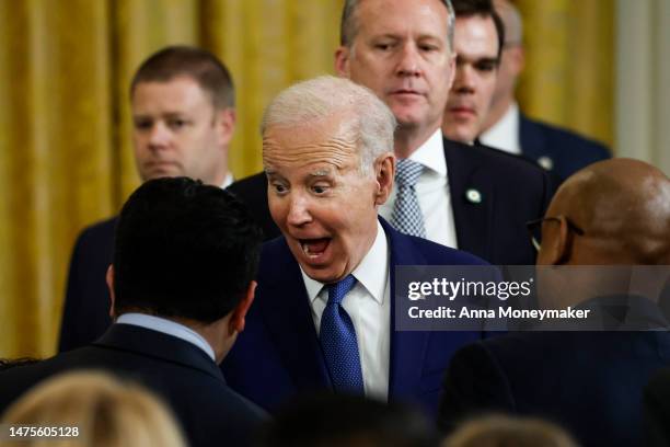 President Joe Biden reacts as he sees Rep. Jimmy Gomez's son Hodge at an event marking the 13th anniversary of the Affordable Care Act in the East...