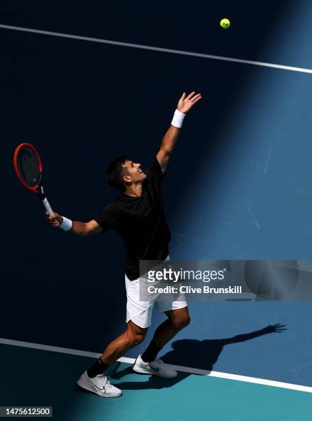 Cristian Garin of Chile serves against Marcos Giron of the United States during his three set victory in their first round match at Hard Rock Stadium...