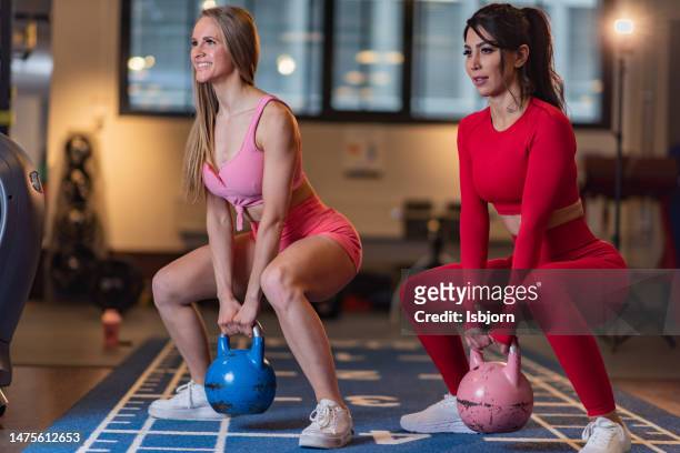 athletic women exercising with kettle bell at the gym - hand weight stock pictures, royalty-free photos & images