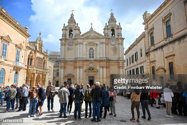 Tourists are seen in front of St. Paul's Cathedral in the fortified city of Mdina, on March 22, 2023 in Mdina, Malta.