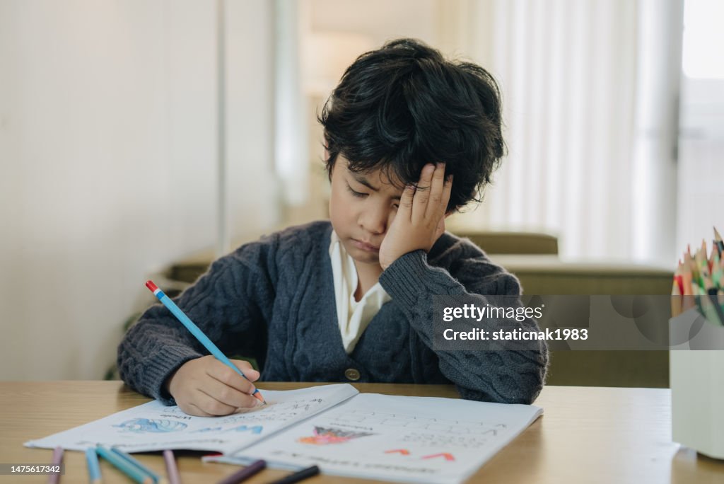 Asian child working on hard homework