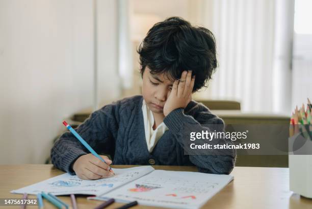 asian child working on hard homework - i hate homework stock pictures, royalty-free photos & images