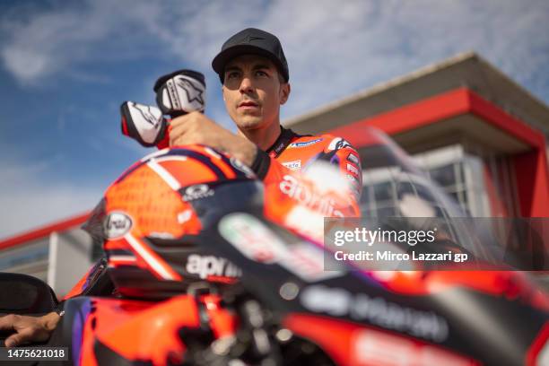 Maverick Vinales of Spain and Aprilia Racing looks on near the bike on grid during the MotoGP Of Portugal - Previews at Autodromo do Algarve on March...