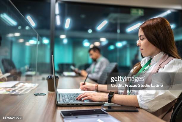 young businesswoman working in the office - employee badge stock pictures, royalty-free photos & images