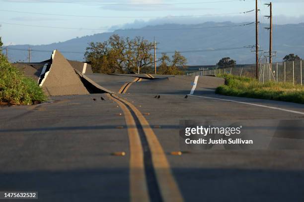 View of a road that buckled when it was undermined by a mudslide during a Bomb Cyclone storm earlier in the week on March 23, 2023 in Novato,...