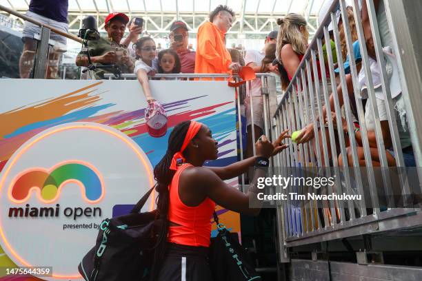 Coco Gauff of the United States greets fans following a match against Rebecca Marino of Canada during the Miami Open held at Hard Rock Stadium on...