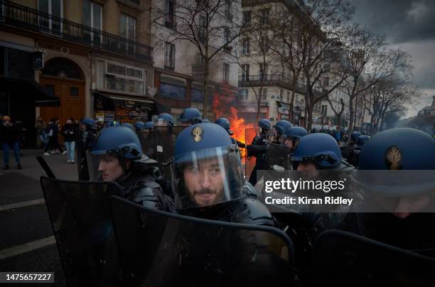 Riot police face protestors during violent clashes over the government's reform of the pension system on March 23, 2023 in Paris, France. Over 1...