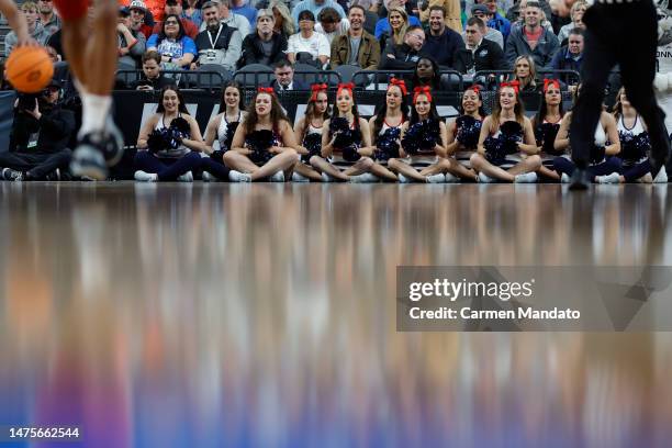 The Connecticut Huskies cheerleaders are seen during the first half against the Arkansas Razorbacks in the Sweet 16 round of the NCAA Men's...