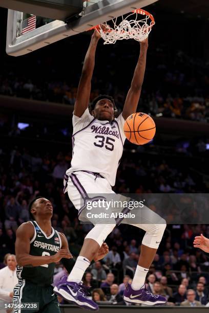 Nae'Qwan Tomlin of the Kansas State Wildcats dunks the ball against the Michigan State Spartans during the second half in the Sweet 16 round game of...