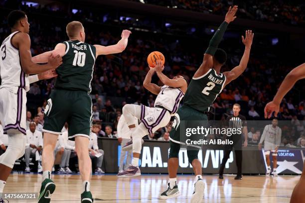 Markquis Nowell of the Kansas State Wildcats falls to the court as he shoots the ball against the Michigan State Spartans during the second half in...